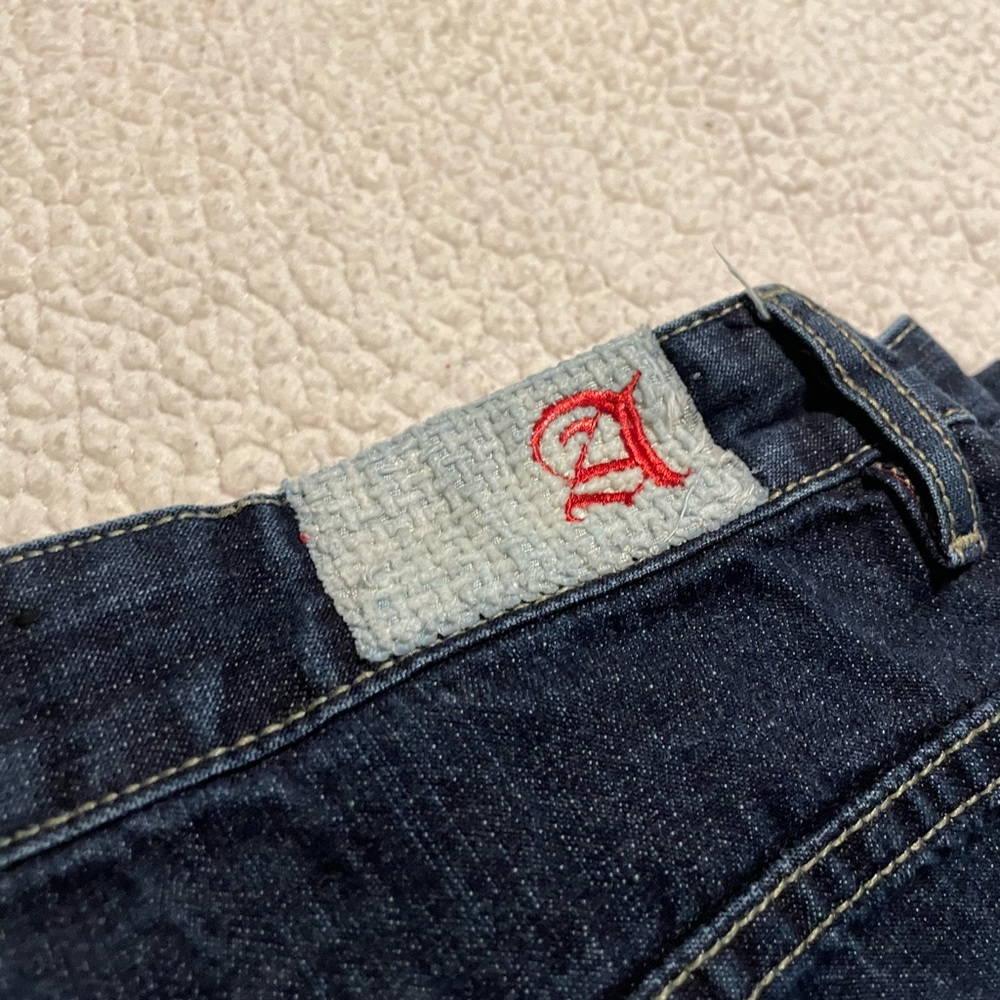 dark wash men’s jeans with embroidered back pockets